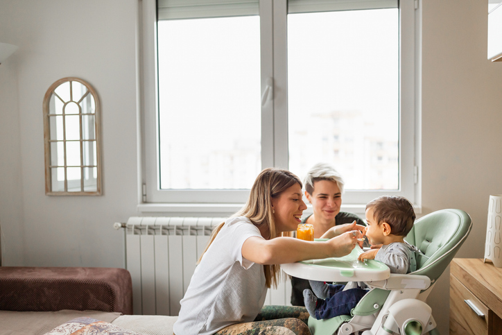 Family life. Lesbian couple with baby at home.
